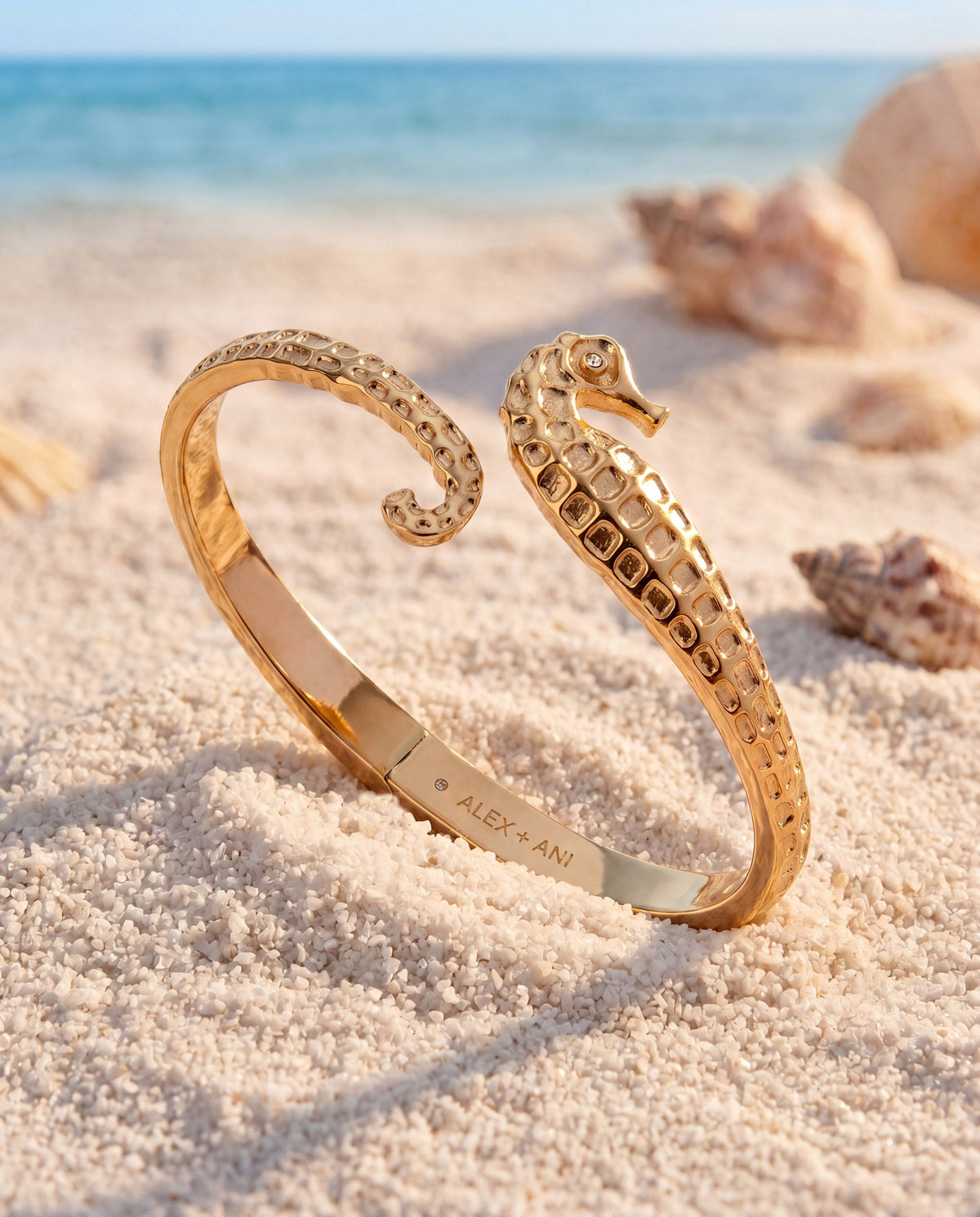 Gold seahorse cuff bracelet with crystal-eyed seahorse head and textured band