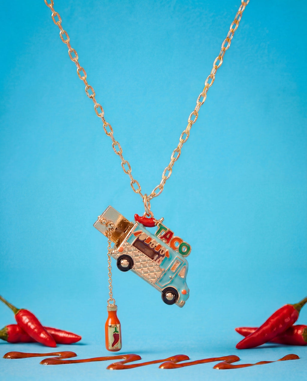 Gold taco truck locket necklace with taco truck pendant and dangling chili bottle charm.