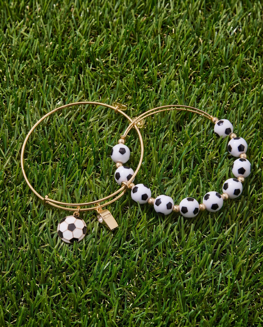 Two gold-tone soccer ball beaded bangle bracelets with black-and-white bead balls