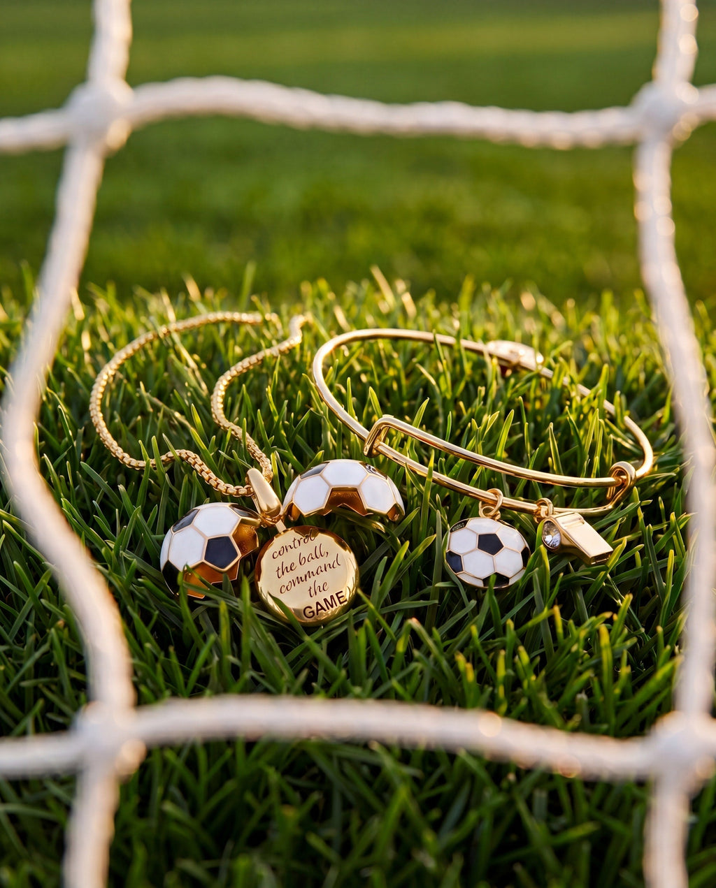 Gold soccer ball locket necklace on grass with multiple soccer ball charms and round locket