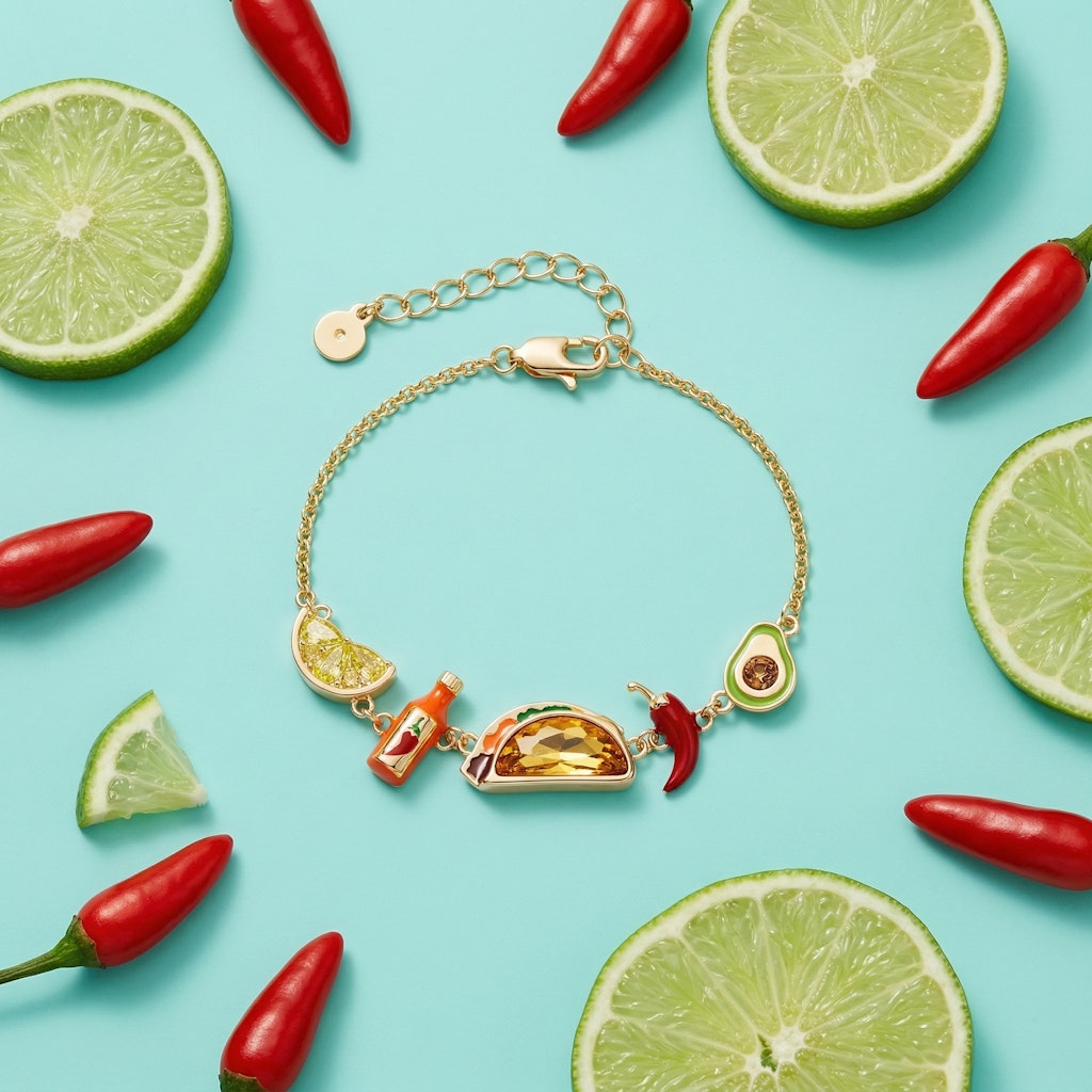Gold-tone taco charm bracelet with lime slice, red chili, and amber taco centerpiece
