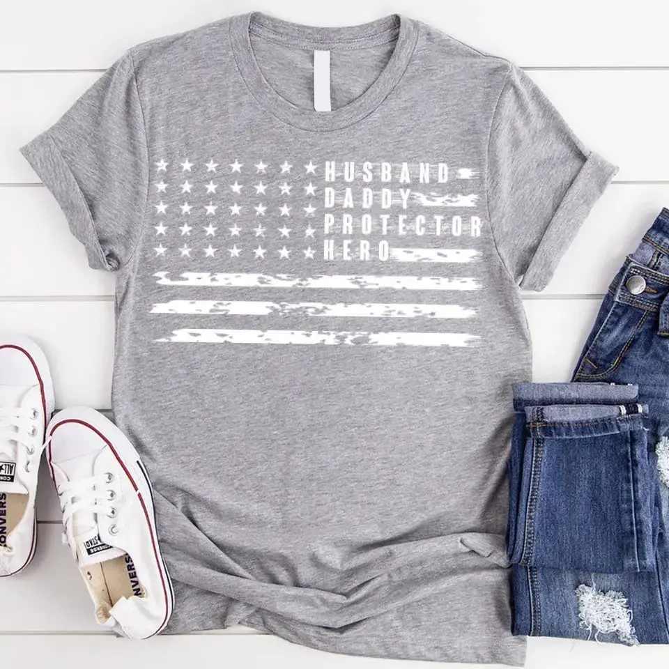 Grey crewneck T-shirt with star flag stripes and 'Husband Daddy Protector Hero' print.