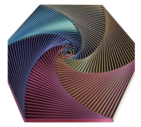 Hexagon sensory fidget toy with blue, teal, tan, and magenta ridges forming a spiral