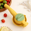 Manual citrus juicer press with yellow body and green press plate, compact handheld form