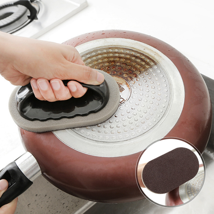 Emery cleaning tool pad applied to a nonstick pan surface