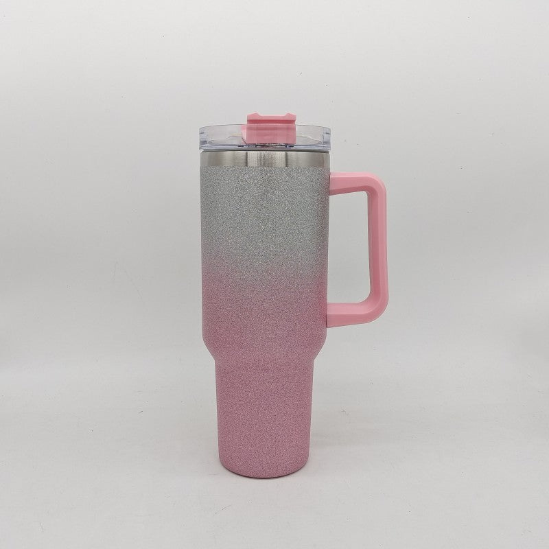 Insulated stainless steel tumbler with rose-to-gray gradient finish, handle, and clear lid