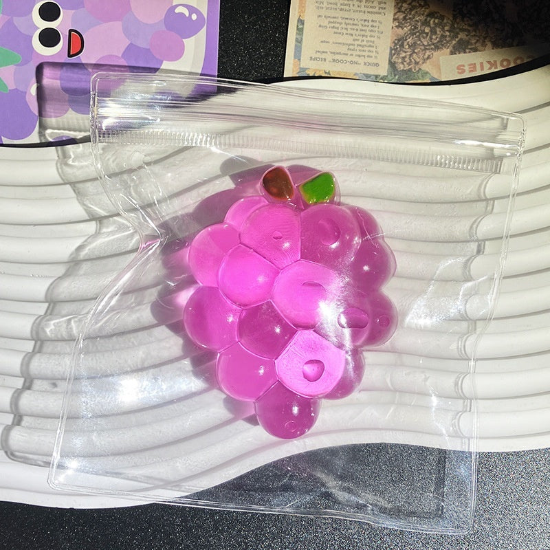 Purple transparent grape stress-relief toy in clear plastic pouch with zipper