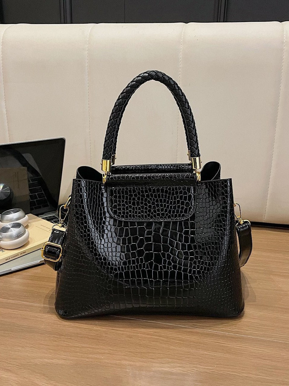 Black croc-embossed structured crossbody bag with top handles, front flap, and strap