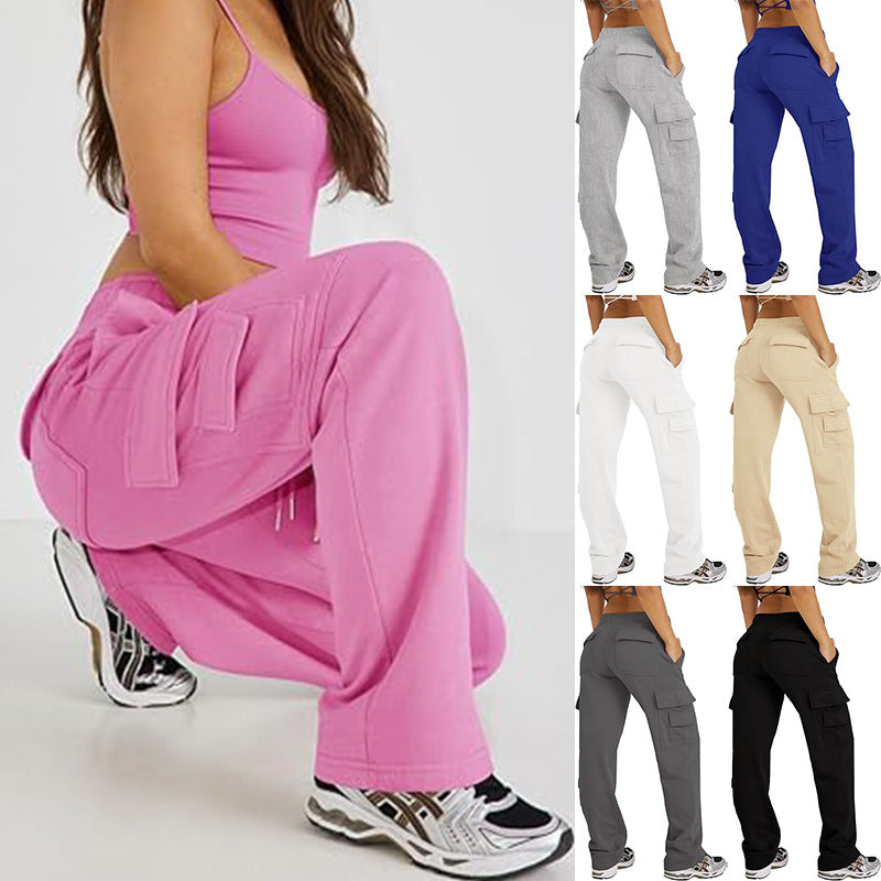 Pink cargo pants with loose wide-leg fit and multiple flap side pockets