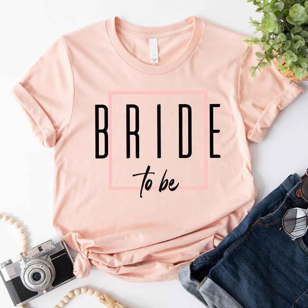 Bride to be print peach crewneck T-shirt with black letters and pink outline