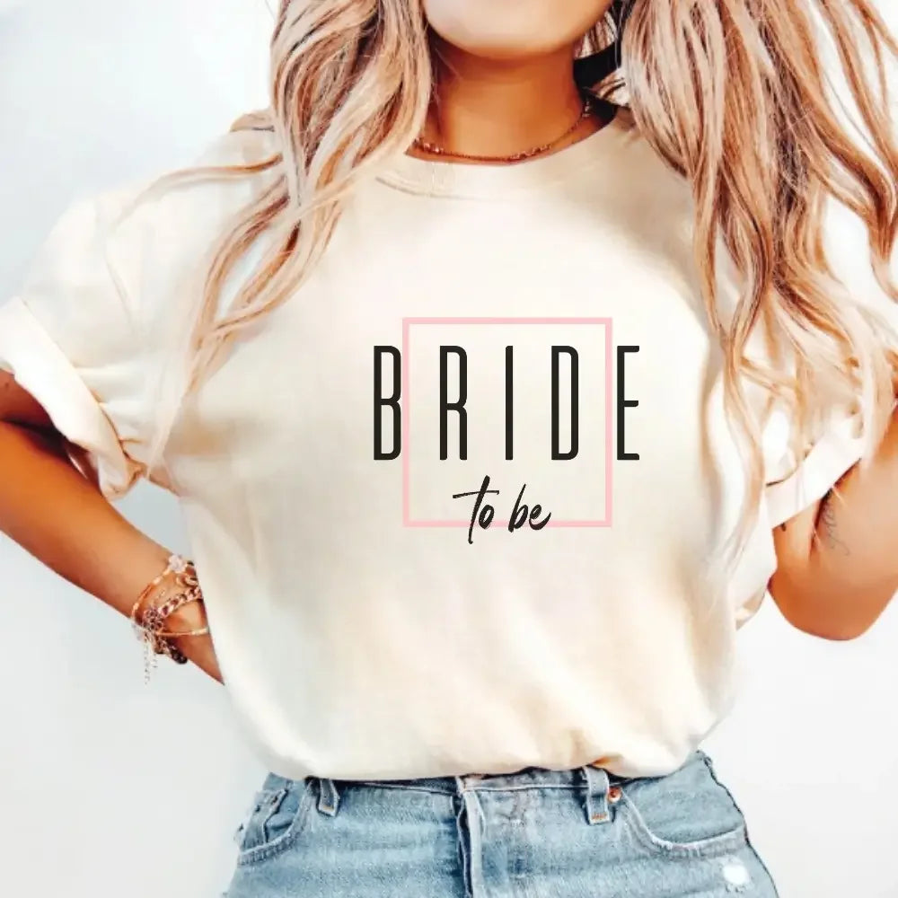 Cream crewneck T-shirt with “BRIDE to be” graphic in a pink outlined square