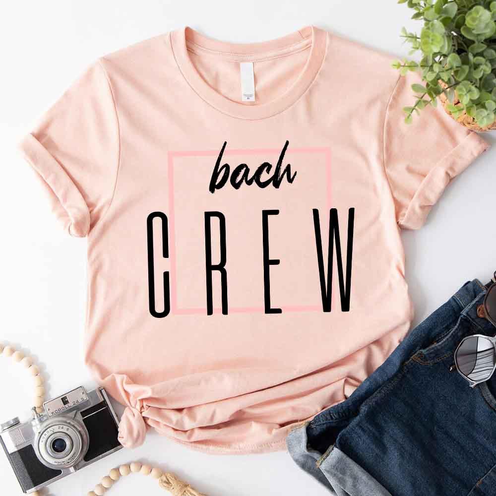 Light pink crewneck T-shirt with “bach” and large “CREW” lettering graphic