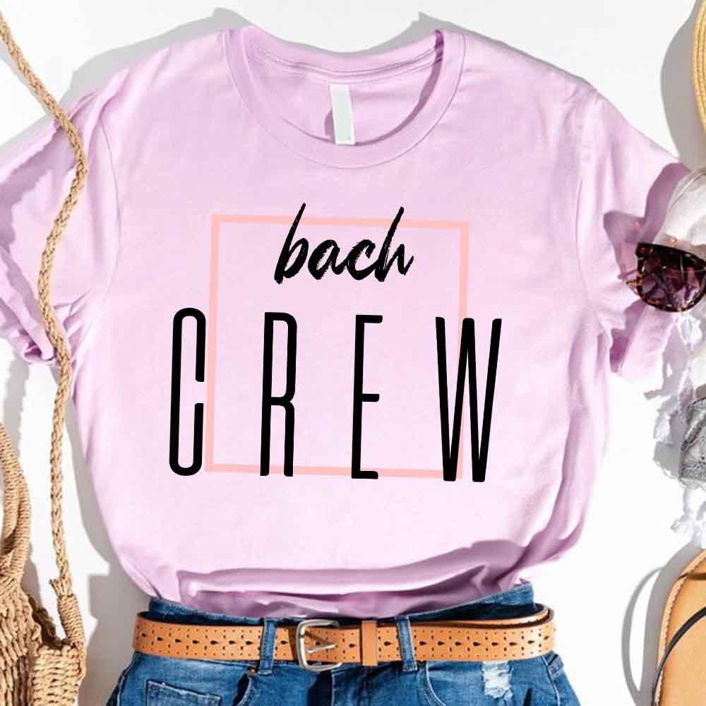 Light lavender crewneck T-shirt with “bach” and “CREW” graphic in pink box
