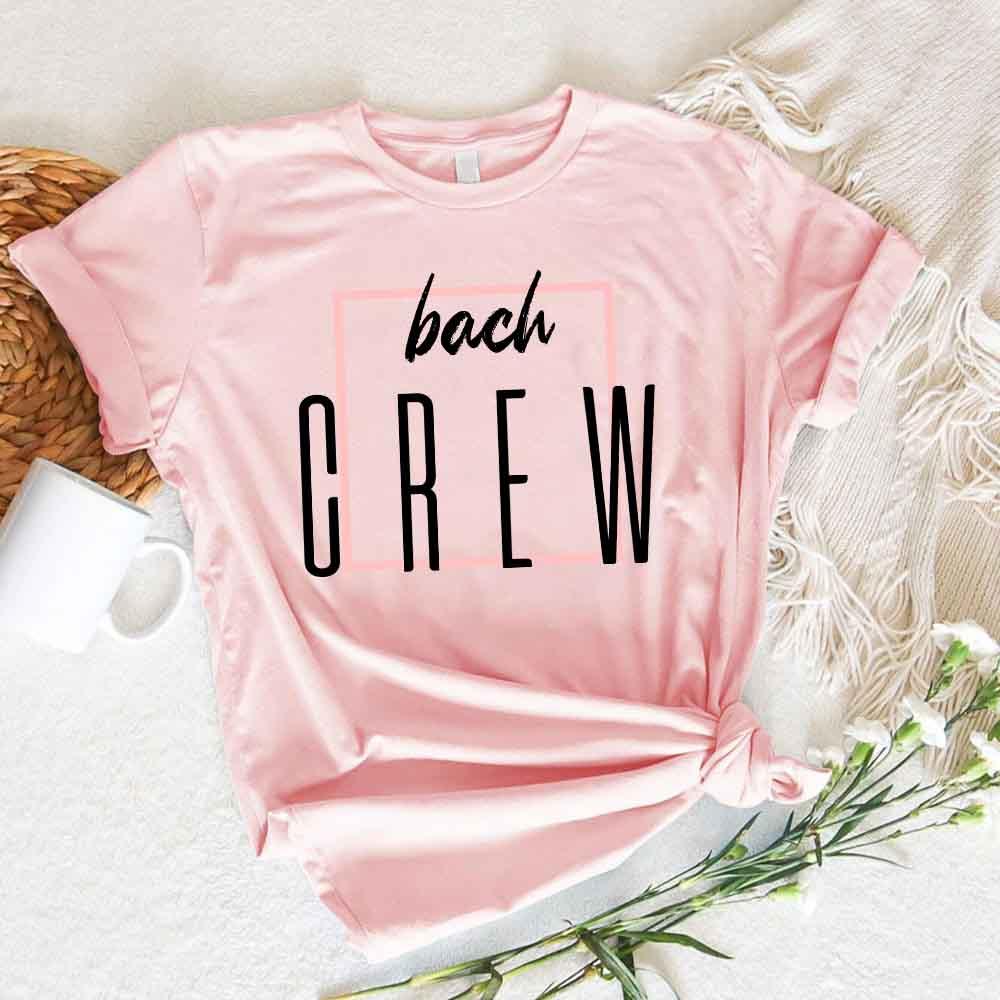 Soft pink crewneck T-shirt with “bach” and “CREW” lettering graphic