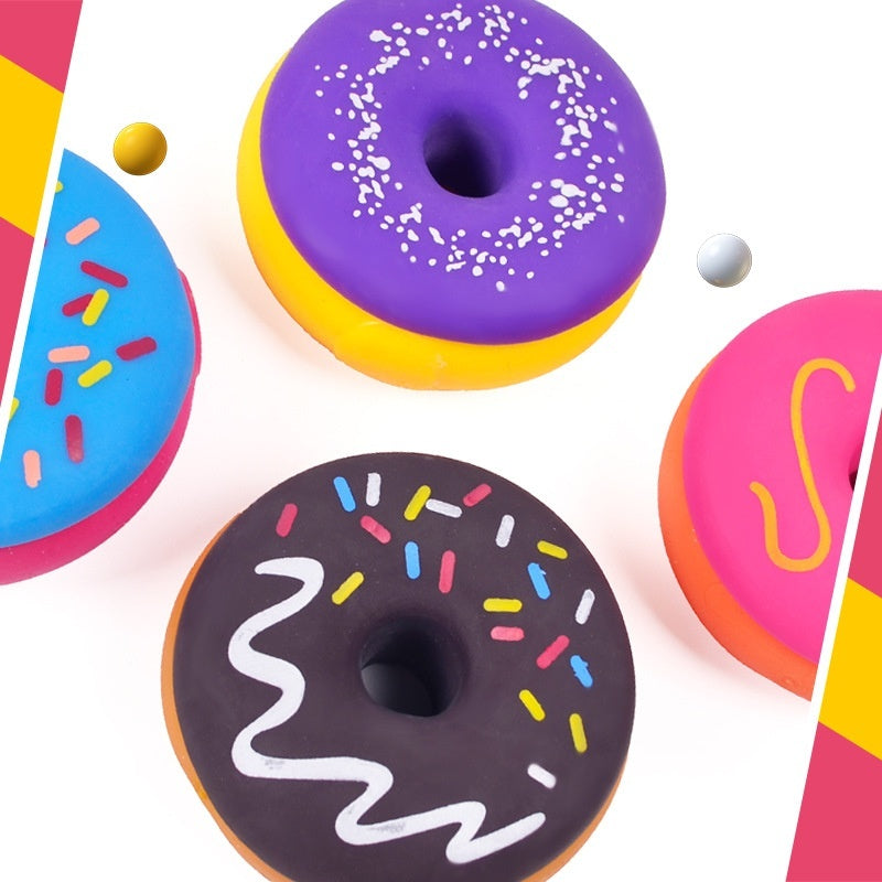 Assorted squishy donut stress-relief toys with sprinkle, zigzag, and smile graphics in purple and black