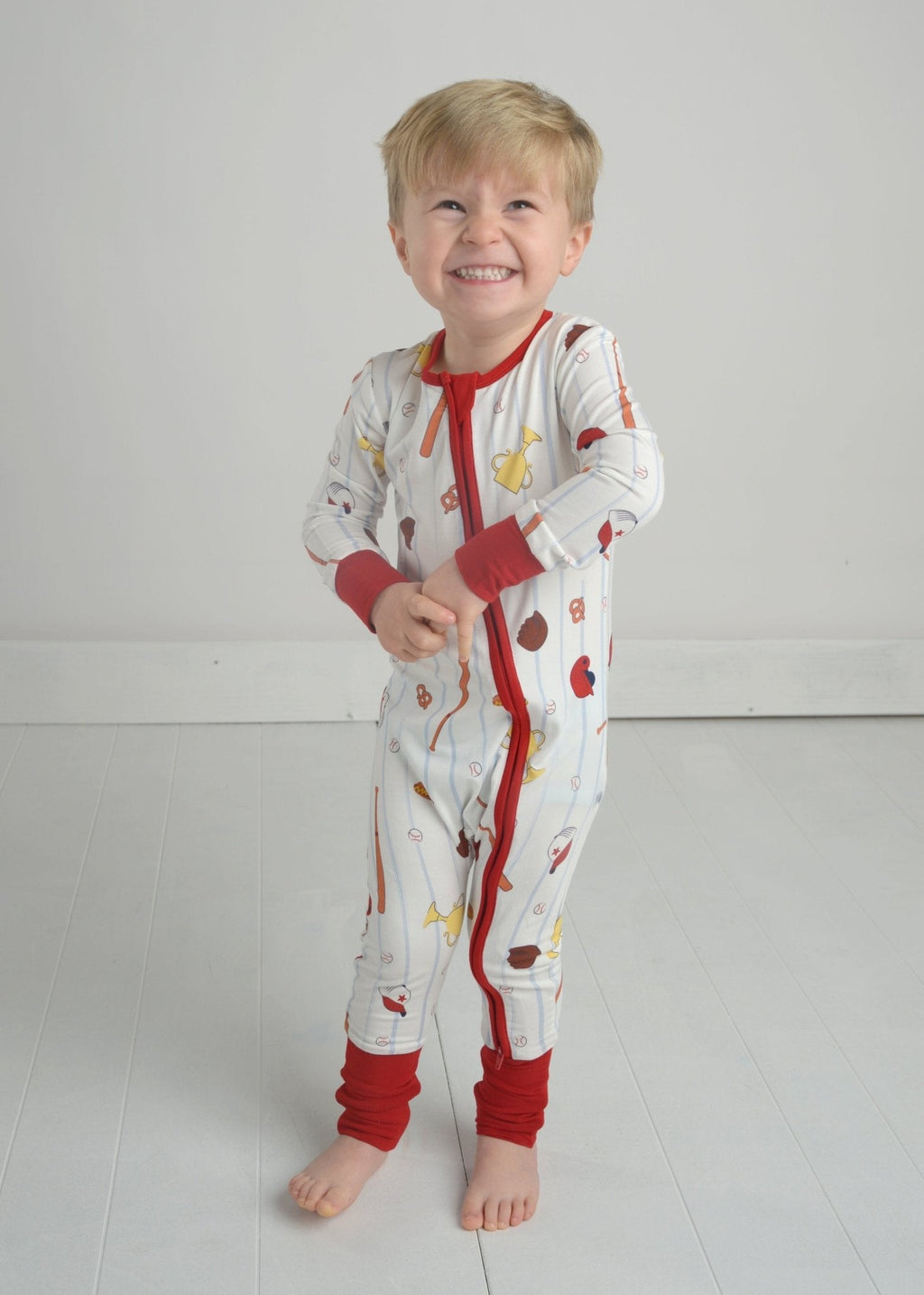 Toddler baseball pajama romper with zipper front, multicolor print, red cuffs and trim