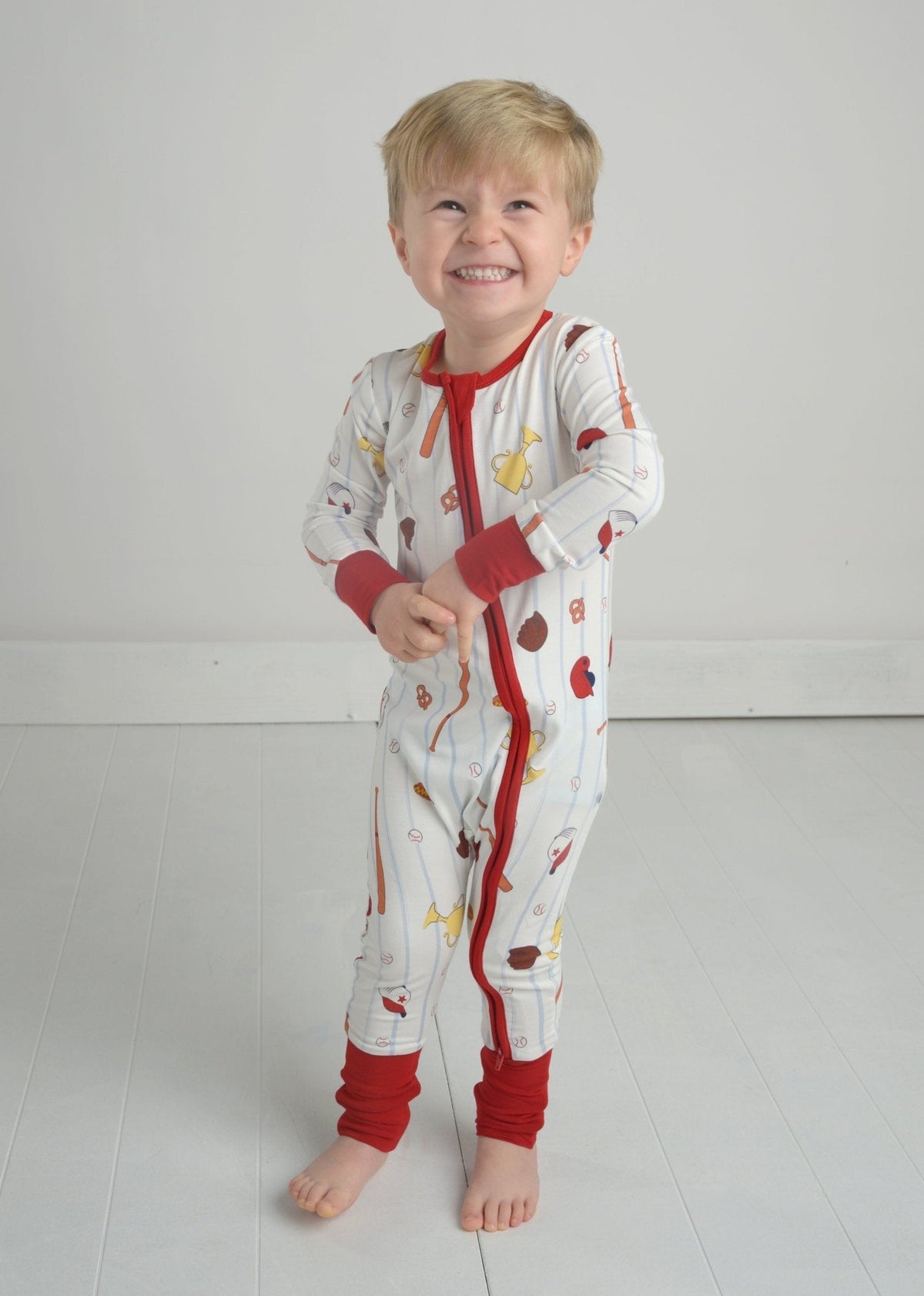 Toddler baseball pajama romper with zipper front, multicolor print, red cuffs and trim