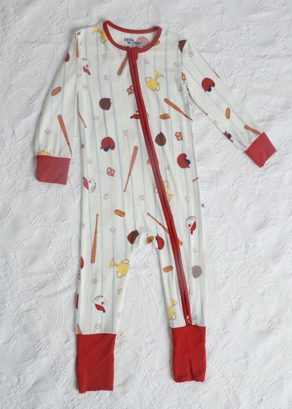 Toddler baseball pajama romper, long sleeves with red cuffs and zipper front; multicolor print