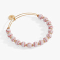 Gold baseball beaded bangle with white and red ball beads and small gold charms