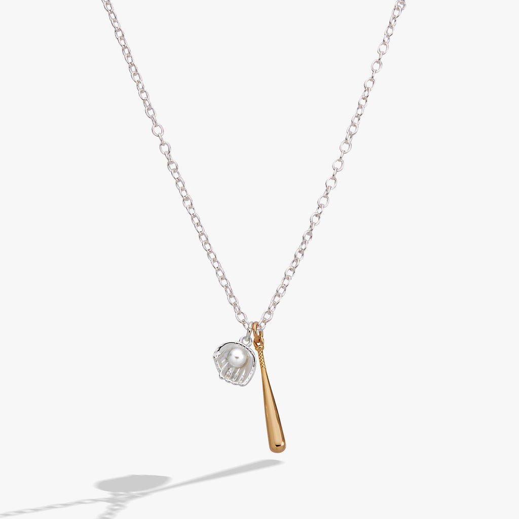 Two-tone pendant necklace: silver chain, helmet charm, gold bat charm