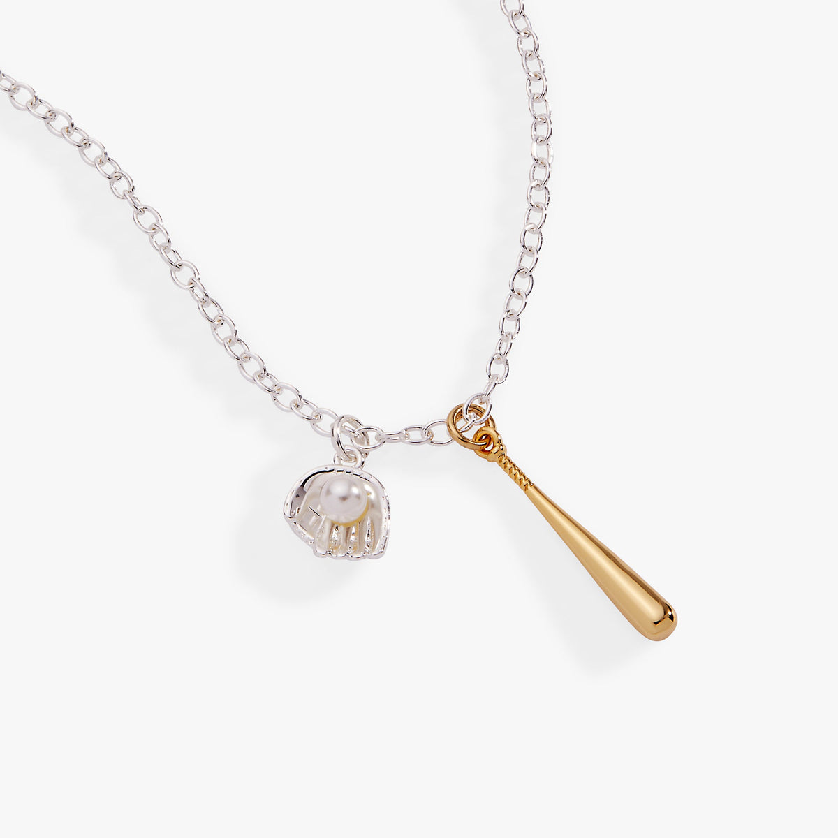 Two-tone pendant necklace with silver chain and two charms: helmet and gold bat