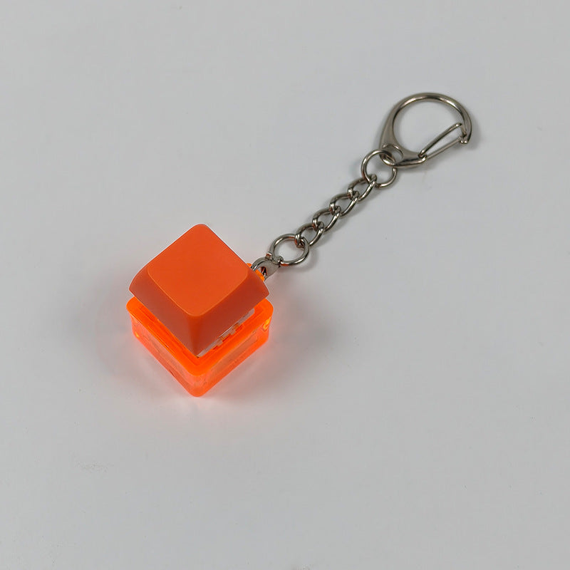 Orange cube stress-relief keychain toy with finger-popping button and metal chain