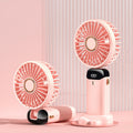 Light pink portable mini fan with LED display, standing base and compact handheld fan
