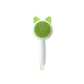 Self-cleaning cat massage brush with green bristle pad, white handle, and hanging loop