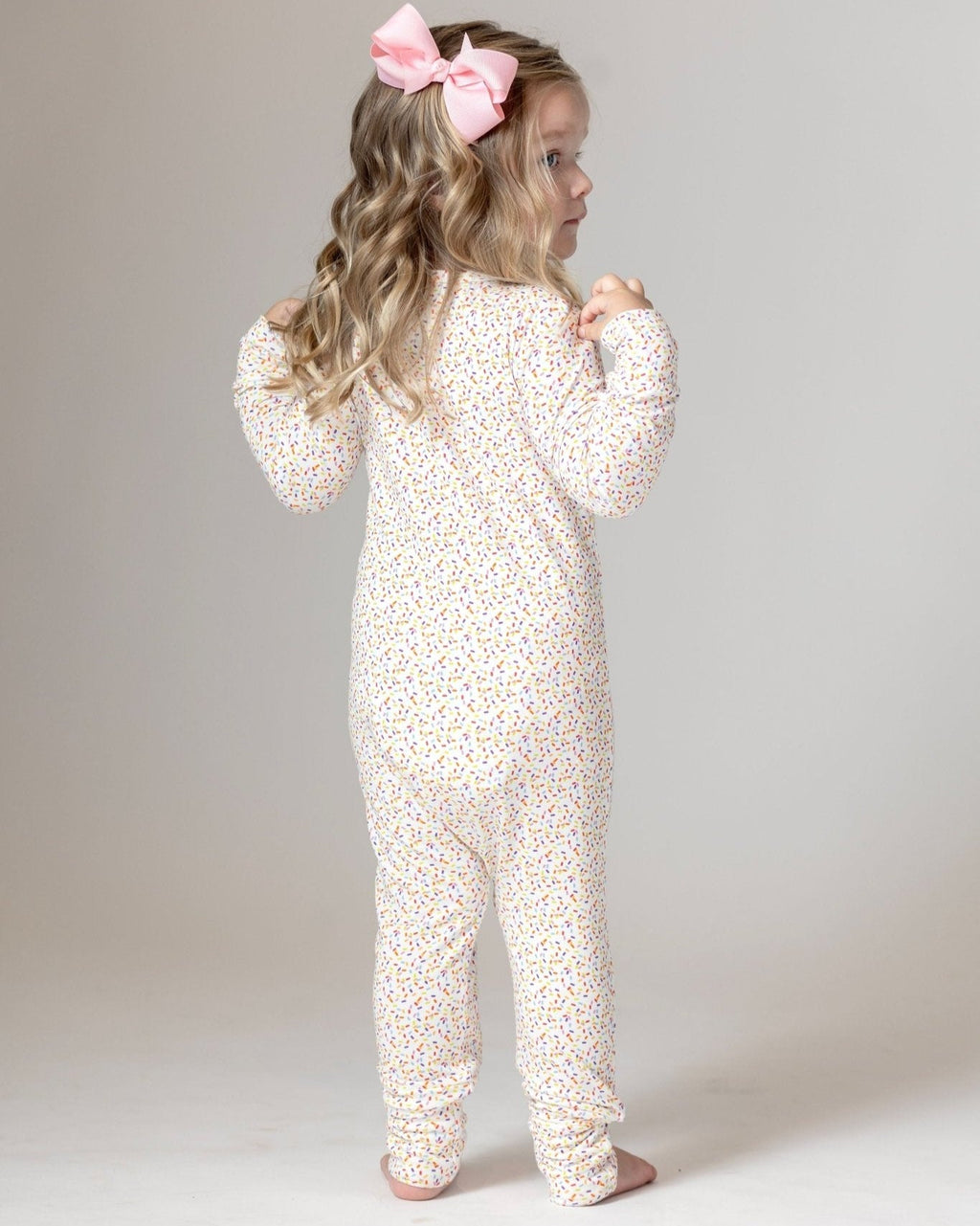 White confetti-sprinkle toddler pajama romper with long sleeves, back view