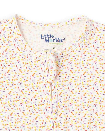 White confetti-sprinkle pajama romper zipper pull close-up, two-way zip