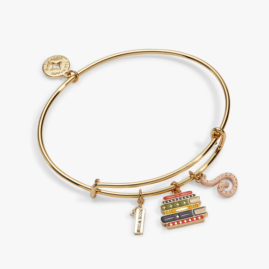 Gold charm bangle with stacked-book charms and pink octopus-shaped charm