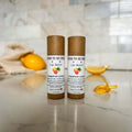 Lip balm stick in tan push-up tube labeled Grapefruit Lemon