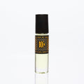 Perfume body oil in clear bottle with black cap and gold geometric label