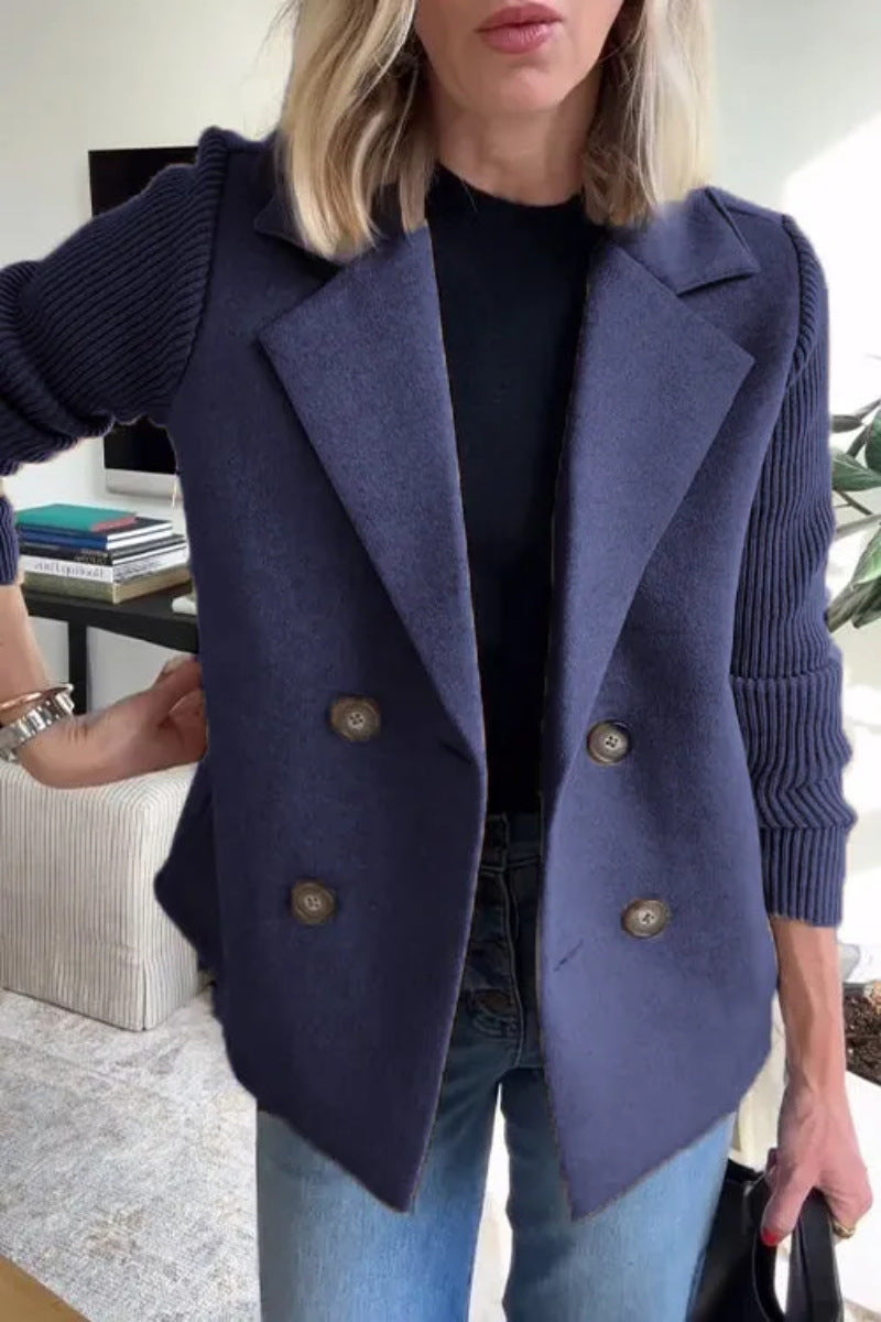 Navy blue double-breasted lapel jacket with ribbed knit sleeves and four button closure.
