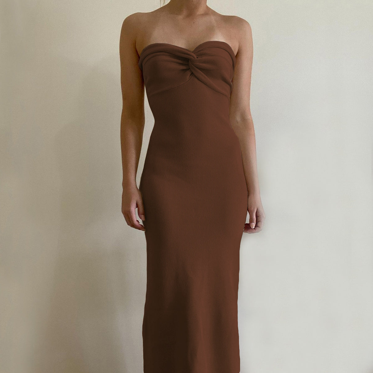 Brown off-shoulder knit long dress with knotted bust and smooth fitted column.