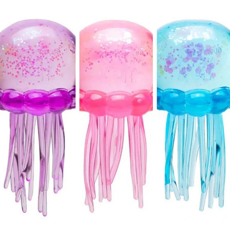 Octopus squishy toys in purple, pink, and blue with long dangling tentacles