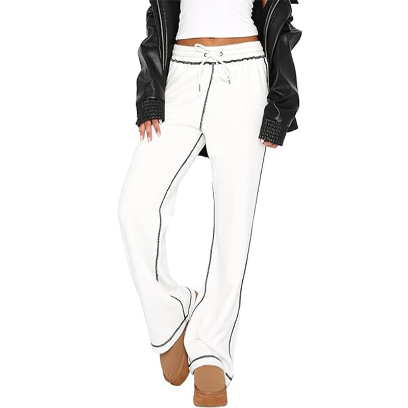 White jogger sweatpants with drawstring, elastic waist, and dark side stripe