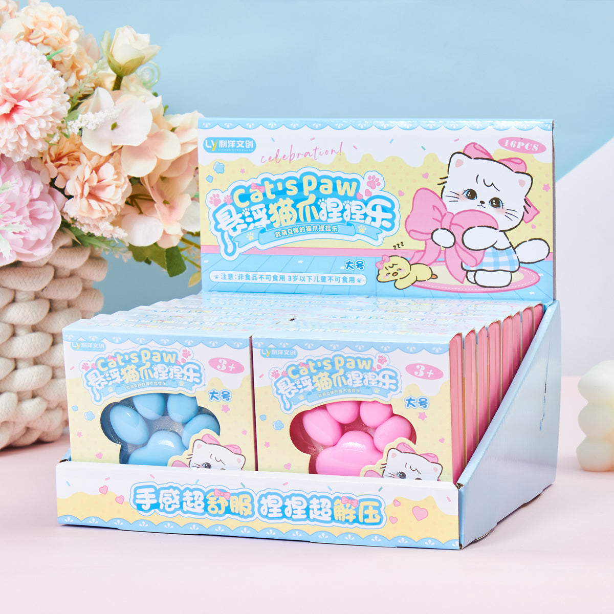 Crystal-clear cat-paw squeeze toy in blue, sealed in retail box packaging