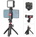 Black vlog selfie stick with LED fill light, phone clamp, and tripod legs