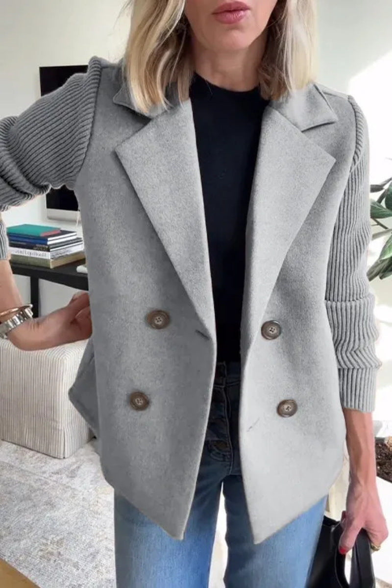 Light gray double-breasted lapel jacket with ribbed knit sleeves and four buttons.