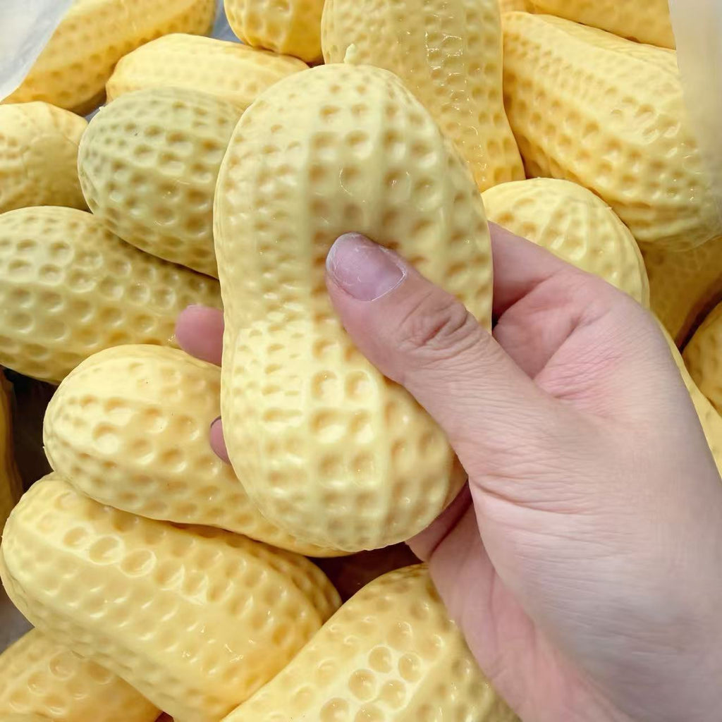 Yellow peanut squeeze stress toy stretched over hand