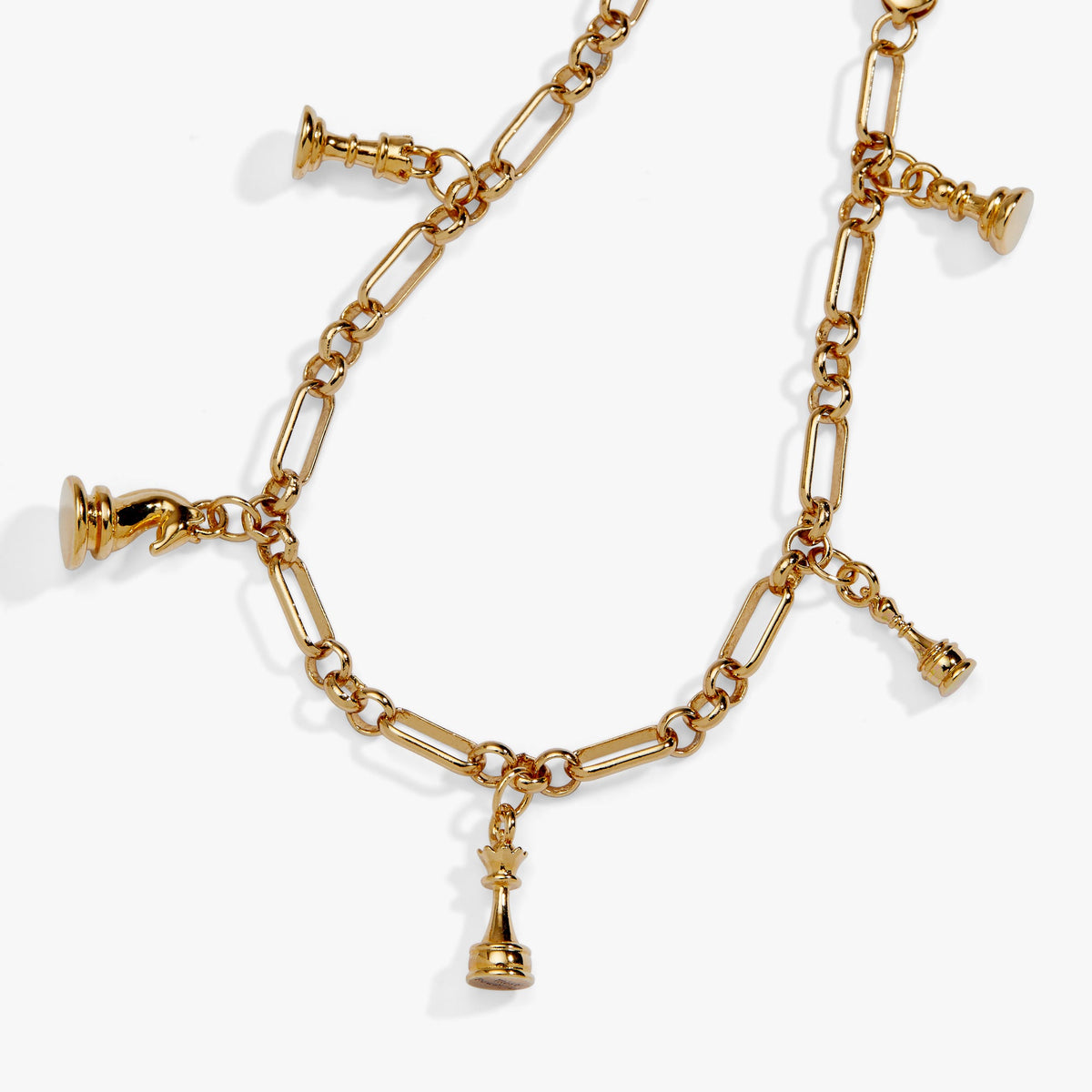 Gold charm bracelet with multiple dangling chess-piece charms on linked chain