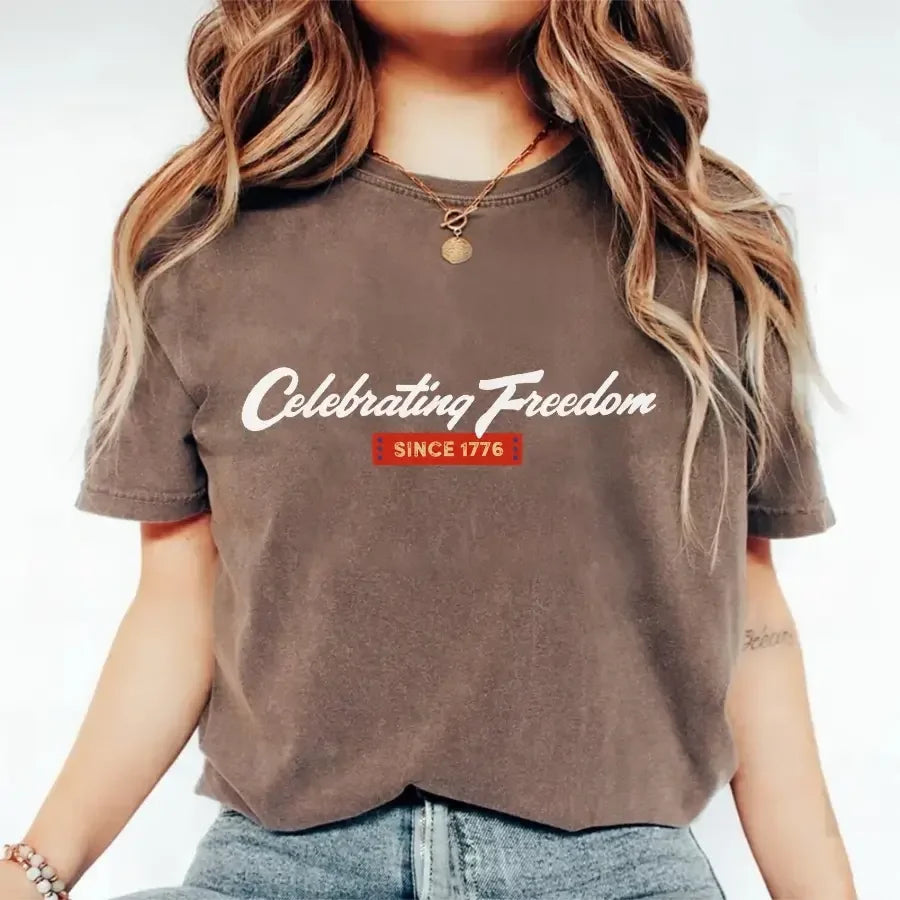 Brown graphic t-shirt with “Celebrating Freedom” and “Since 1776” print