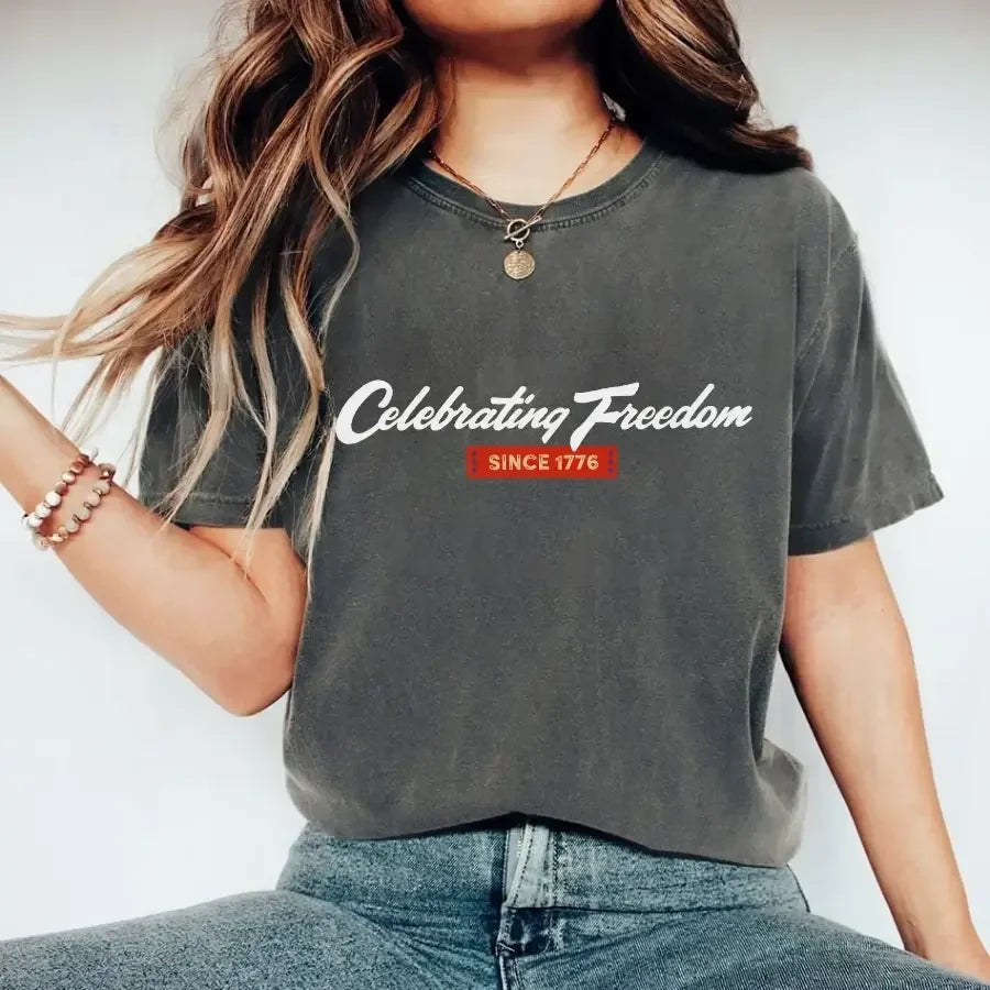 Dark gray graphic t-shirt with “Celebrating Freedom” and “Since 1776” print