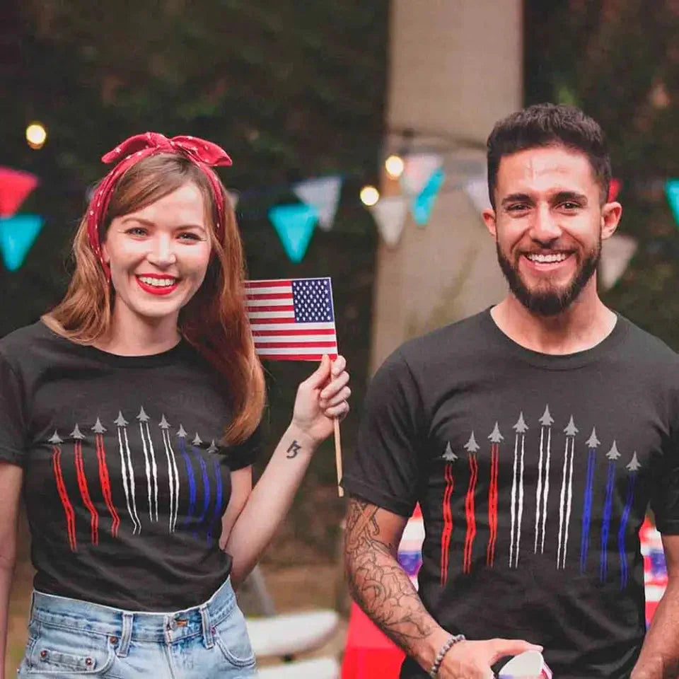 Two people wearing black crewneck T-shirts with red, white, and blue vertical stripe graphic