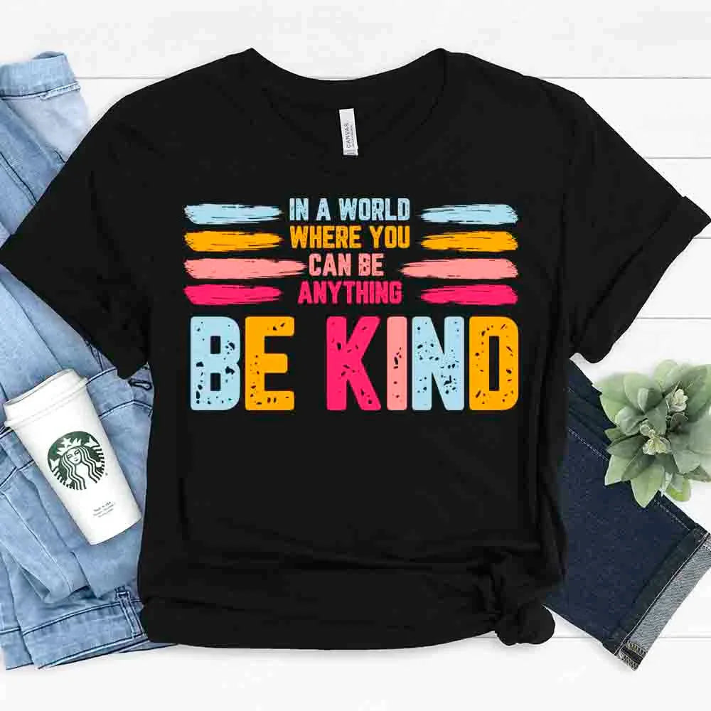 Black Be Kind graphic tee with colorful “BE KIND” print and stacked slogan text