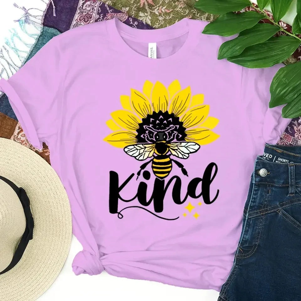 Lilac T-shirt with sunflower, bee, and “kind” graphic on the front.