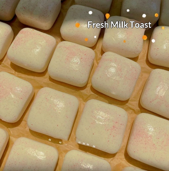 Cream mini toast squishy squeeze toy with tiny speckles, arranged in rows