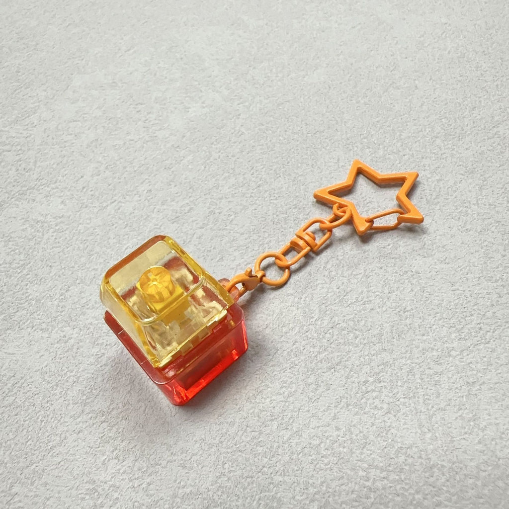 Orange cube mechanical keyboard stress-relief keychain with star charm and chain