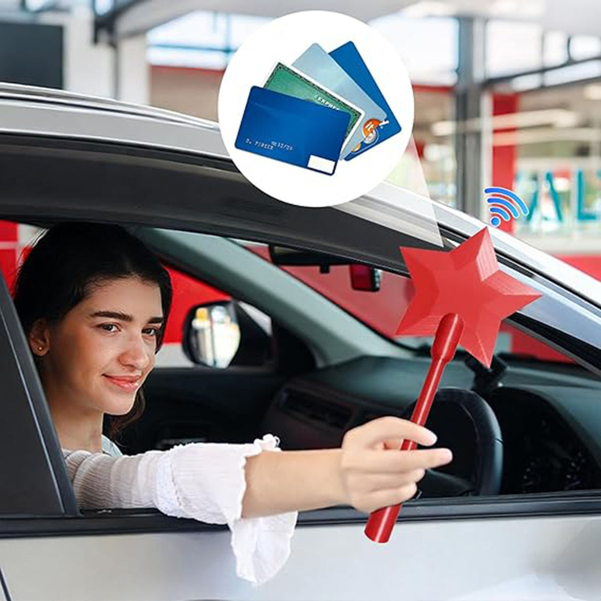 Red star-tipped tap-to-pay NFC payment wand held by driver inside car